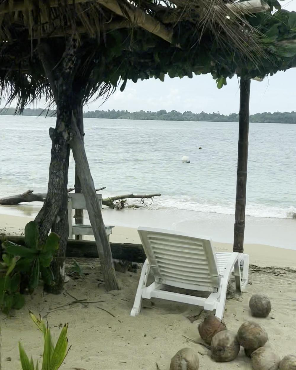 Thatched rancho on a beach facing the lagoon