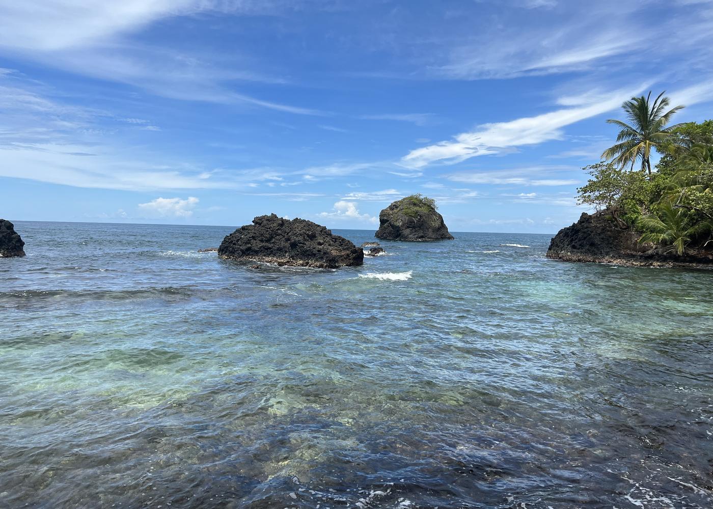 Rock formations off a jungle shoreline